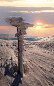 Snow covered pointer near path on snowy mountain plateau and sunshine in sk.. 写真素材
