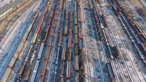 Snow-covered rail yard on edge of Iași Romania. Parallel lines of parked wagons Stock Footage 327405359