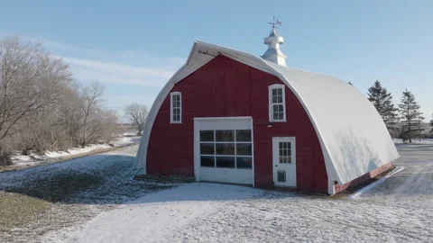 Snow-Covered Red Barn with Weather Vane in Rural Winter Setting Stock Footage 267023285