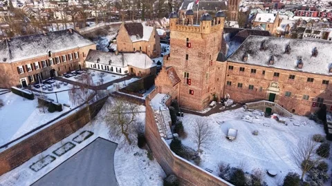 Snow covered red brick castle complex with towers, walls, and inner courtyards Stock-Footage 327981685