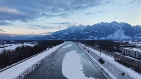 Snow-covered Rhine River between Liechtenstein and Switzerland 스톡 동영상 329558267