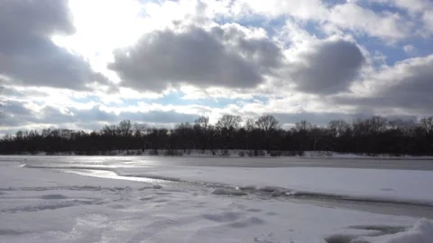 Snow-covered river and clouds in time lapse Stock Footage 159540426