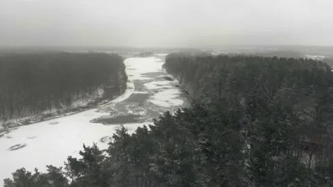 Snow-covered river valley in a forest area Video stock 149227951