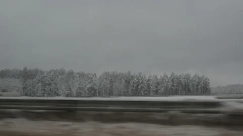 Snow-covered road and forests from the car window. winter trail is dangerous Stock Footage 146207142