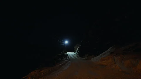 Snow Covered Road Beneath Bright Streetlight at Night in Arctic Norway Vidéo 339843131