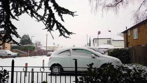 Snow-covered road, marks of wheel in the snow. Cars under the snow. 4k Stock Footage 148761350