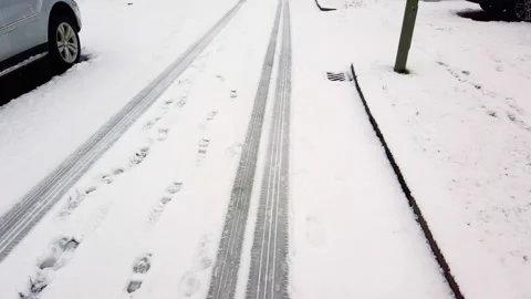 Snow-covered road, marks of wheels in the snow. City street after snowfall 4k Stock-Footage 148752595