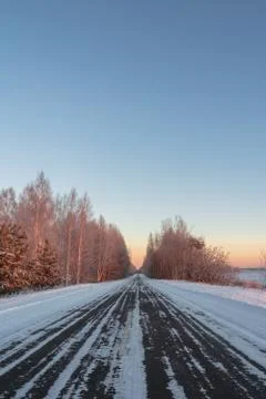 Snow-covered road in rural Russia of a frosty morning, around a field and for Stock Photos
