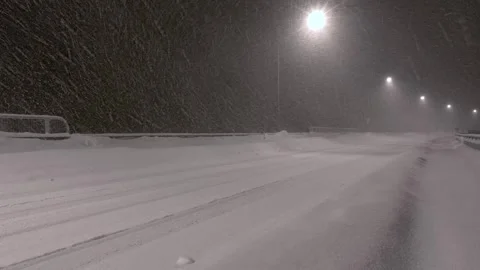 Snow-covered road Snow accumulation Snowy road Night view Stock Footage 306555258