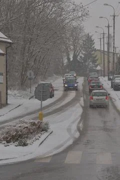 Snow-covered road, wheel marks in the snow and snow-covered cars during heavy Stock Photos