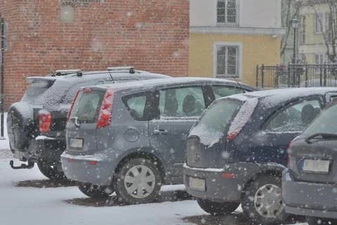 Snow-covered road, wheel marks in the snow and snow-covered cars during heavy Stock Photos