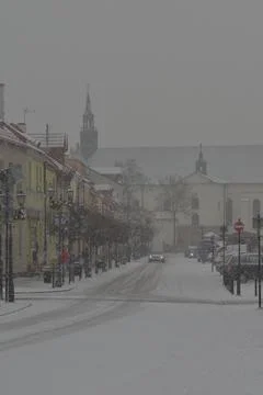 Snow-covered road, wheel marks in the snow and snow-covered cars during heavy Stock Photos