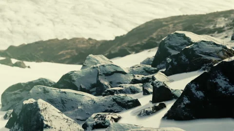 Snow covered rocks on a mountain surface with glacier background Stock Footage 340608803