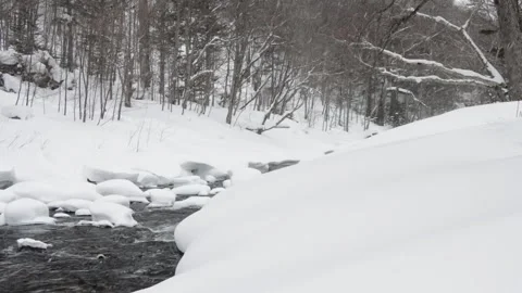 Snow-covered rocks in river bend in snowy Japanese  winter landscape Stock Footage 328807241