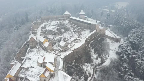 Snow covered roofs inside Rasnov Fortress. Brasov, Romania Stock Footage 321053787