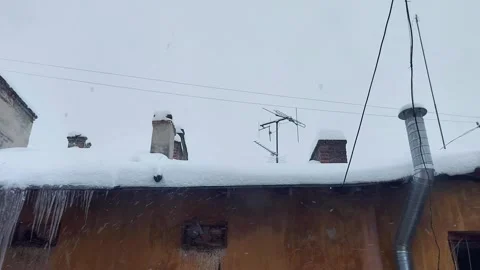 Snow - Covered Rooftop with Icicles, Chimneys, and Antennas in Winter Video stock 326317298