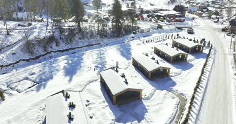 Snow-covered rooftops merge with vast white landscape Stock Footage 318866878