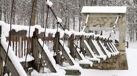Snow Covered Rustic Foot Bridge in Forest Stock-Footage 10842340