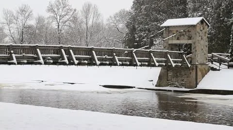 Snow Covered Rustic Foot Bridge Over Icy River Stock-Footage 10845155