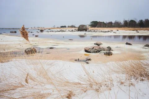 Snow covered seashore on cold spring morning Stock Photos