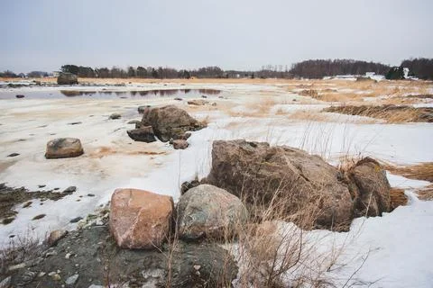 Snow covered seashore on cold spring morning Stock Photos