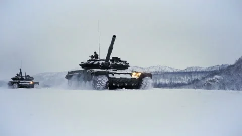 Snow-covered shooting range field on the background of the mountain. Tanks go on Video stock 115860526