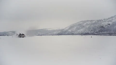 Snow-covered shooting range field in the highlands. Tanks go for testing Video stock 115861053