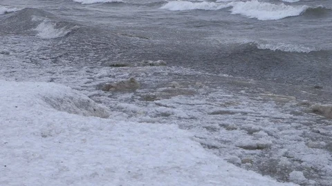 Snow covered shoreline with waves crashing in winter 01 Stock Footage 105981663