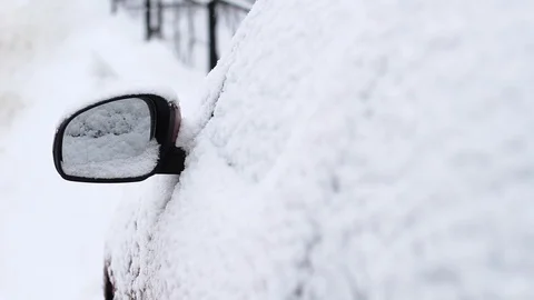 Snow covered side view mirror of a modern car. Stock-Footage 101097236