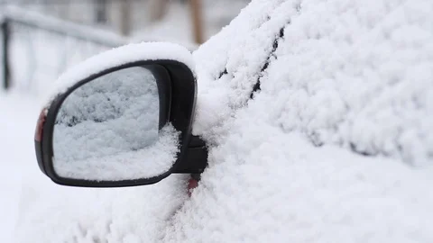 Snow covered side view mirror of a modern car Stock Footage 101788487