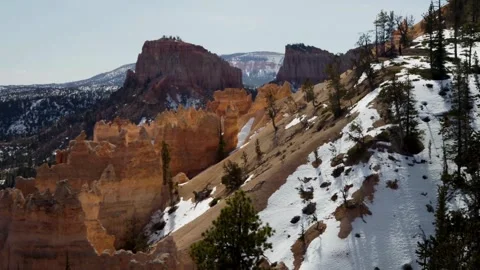 Snow covered slopes and red rock hoodoos at Bryce Stock Footage 329762141