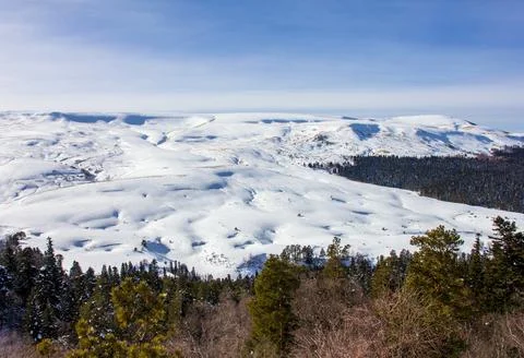 Snow-covered slopes of a mountain range, winter time in a nature park Stock Photos