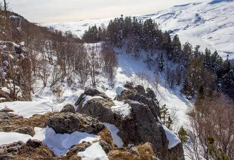 Snow-covered slopes of a mountain range, winter time in a nature park Stock Photos