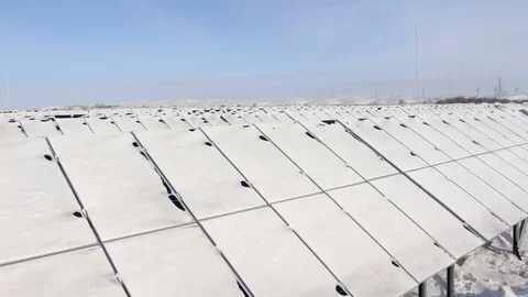 Snow-covered solar panels pan left Stock Footage 72434648