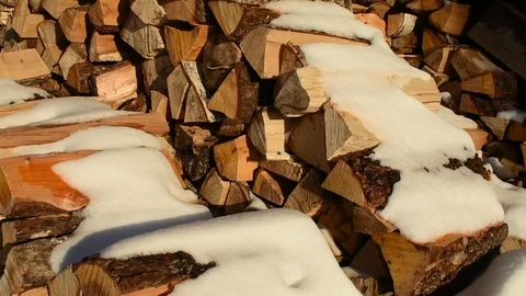 Snow-covered stack of firewood Stock Footage 124410220