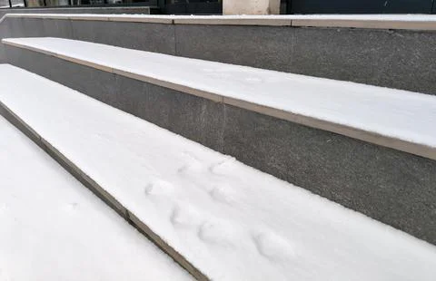 Snow-covered steps, parallel lines.  Grey stone, white snow contrast.  Urba.. Foto stock