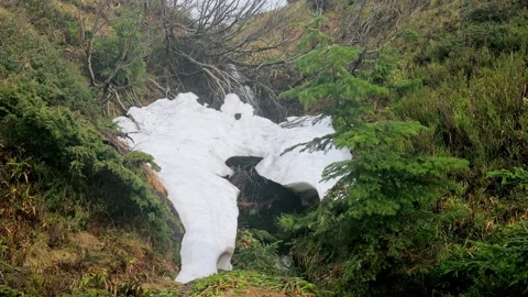 Snow-Covered Stream in the Mountains with Spring Meltwater Stock-Footage 285142394