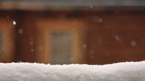 Snow covered surface for product placement. Blurred wooden house wall with Stock Footage 99401442