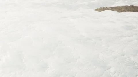 Snow covered surface with a small dark patch in winter Stock Footage 345056427