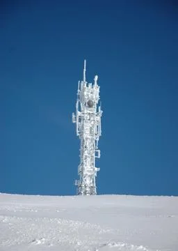 A snow-covered telecommunications tower Stock Photos