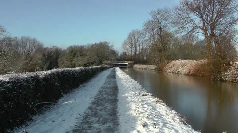 Snow covered towpath blue sky Trent and Mersey canal Stock Footage 46809522