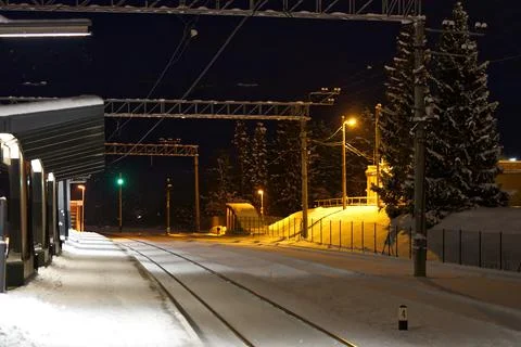 Snow covered train platform at night. Estonia lockal train station. Stock Photos