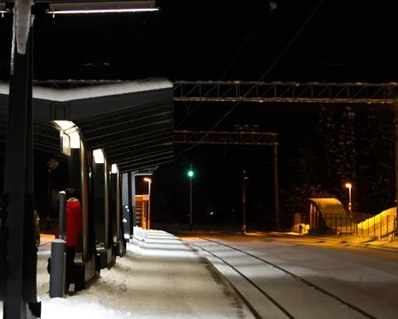 Snow covered train platform at night. Estonia lockal train station. Stock Photos