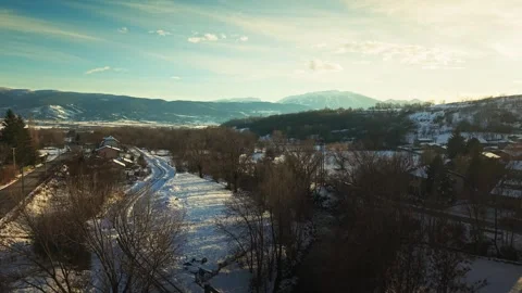 Snow Covered Train Tracks In Enveig With Mountains And Drone Ascending Over Stock Footage 333297895