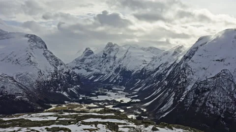 Snow covered valley between huge mountains Stock Footage 267678911