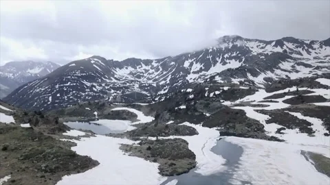 Snow covered valley with lakes in the lower part as seen from the air Video stock 221517072