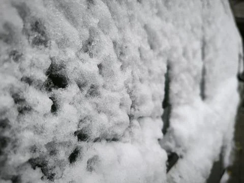 A snow covered wall on it. Stock Photos