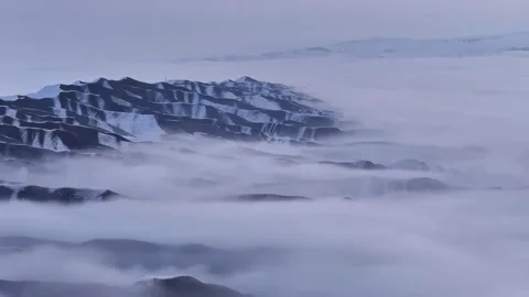Snow-Covered Wavy Mountain Ridges Amidst Atmospheric Fog in Western Sichuan Stock Footage 346424139