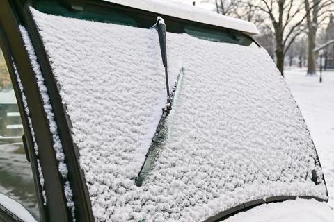 A snow-covered windshield of a campus utility vehicle. 写真素材