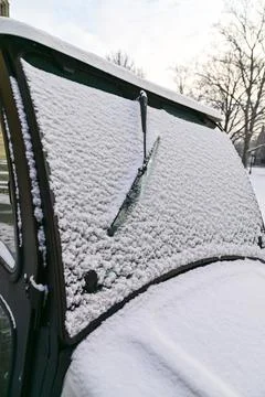 A snow-covered windshield of a campus utility vehicle. Stock Photos